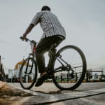 a man riding a bike down a street