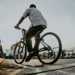 a man riding a bike down a street