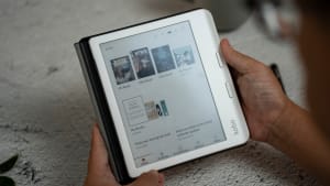 A person holding a tablet with a page on it